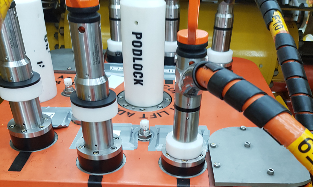 Subsea PODLOCK hydraulic jacking tool on an orange deployment frame